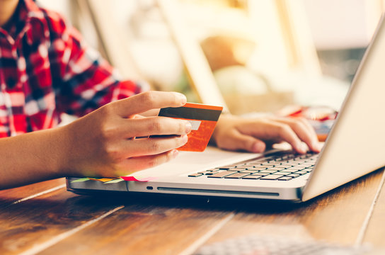 Woman holding credit cards and mobile phones are now shopping over the internet by paying by credit card.