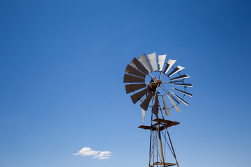Close up wide angle image of a windmill / windpomp with static blades in the Tankwa Karoo in South Africa on a hot summersday