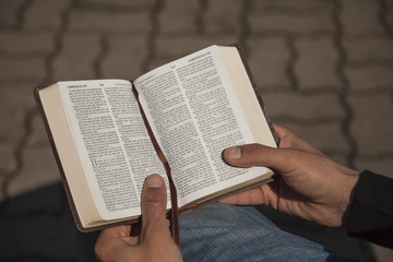 Young man holding and reading holy bible - 143801067