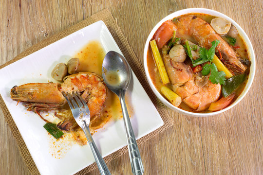Prawn in white dish Tom yum kung in white bowl on wooden table