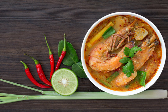 Tom yum kung in white bowl on wooden table, Still life image and Select focus, space for text.
