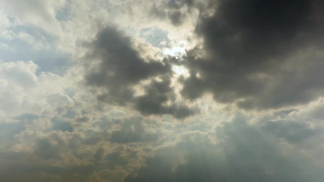 Sun rays through the clouds. Time-lapse recording. Footage 4K, UHD