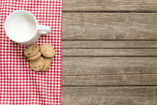 Cute Little Girl Dunking Cookie In Milk Isolated On White Background