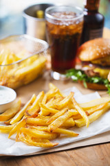 crispy french fries pile with hamburger for launch