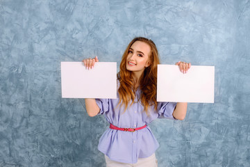 Happy young woman holding two white banners