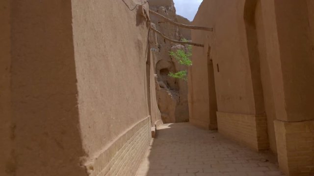street in an old part of the Iranian city, house and wall are constructed of clay bricks