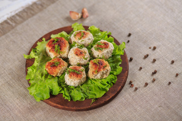 Chicken cutlets with greens on a gray background
