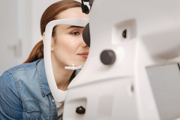 Attractive pleasant woman checking her eyesight
