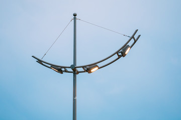 Fototapeta na wymiar Street Lantern Lamppost On Evening Blue Sky Background
