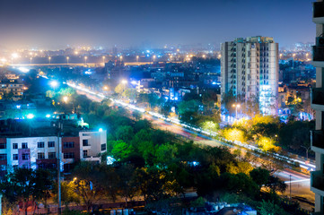 Plakat Noida cityscape at night showing lights, buildings and residences. Shows the urbanization and development of Delhi