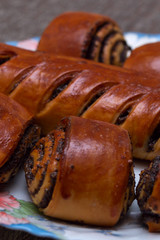 Roll with poppy seeds on a plate. Selective focus.
