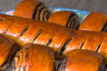 Roll with poppy seeds on a plate. Selective focus.