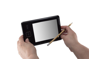 Tablet in the hands of a pensioner with a pencil