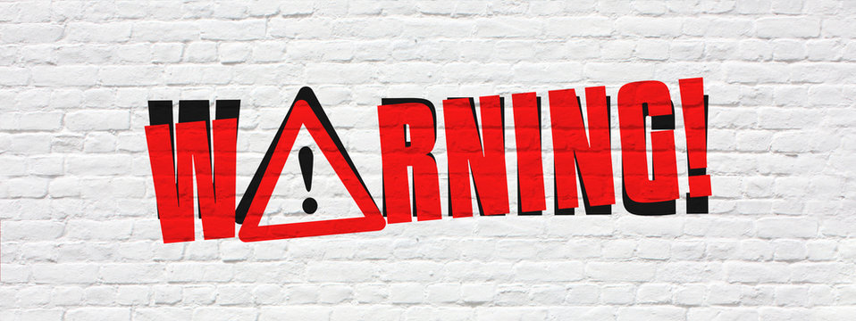 Warning on brick wall banner
