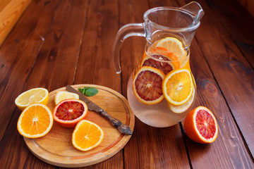 Citrus fruits sliced for lemonade and carafe
