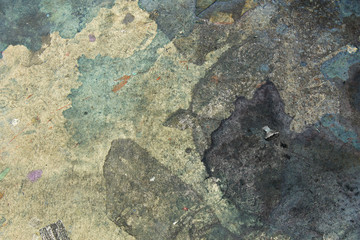 This is a photograph of paint splatter/stains on the floor background