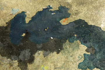 This is a photograph of paint splatter/stains on the floor background