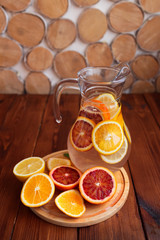 Citrus fruits sliced for lemonade and carafe