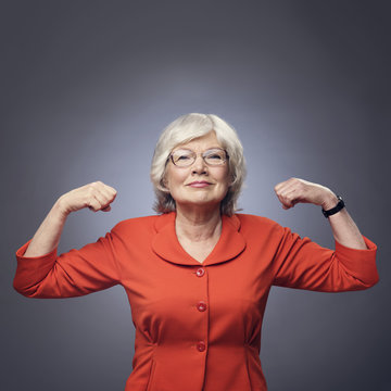 Senior lady showing muscles