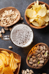 Lager beer and snacks on stone table