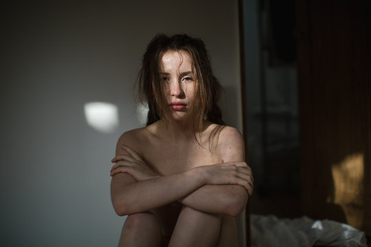 Naked woman feeling vulnerable