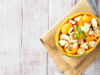 Vegan cantaloupe melon salad with tofu cheese, herbs and cucumber. Healthy summer fresh lunch