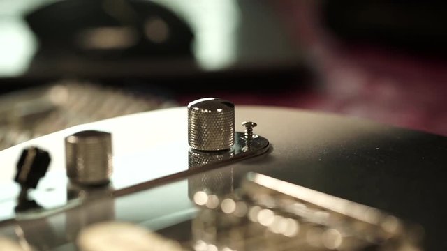 The screw-driver twists a screw Repair of a guitar