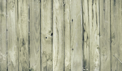 Obraz premium Vertical wooden fence close up. Natural look wood plank background or texture. Vintage filter.