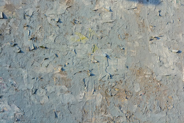 Grey cracked painting on old plaster wall surface