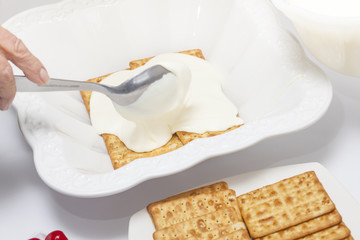 Napoleon dessert preparation : Adding chantilly cream over the cookies