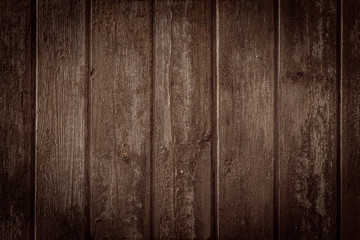 Old rural wooden wall in dark brown colors, detailed plank photo texture. Natural wooden building structure background.