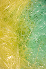 This is a photograph of Green and Yellow shredded plastic fake Easter grass background
