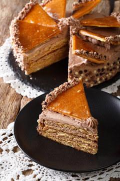 Delicatessen piece Hungarian Dobosh cake with caramel close-up. vertical