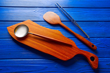 Chef tools tweezers and spatula on wood