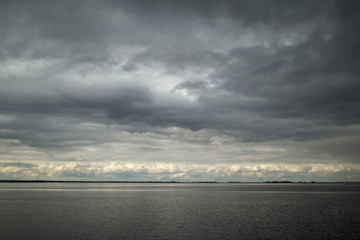 Obraz premium the landscape - the water and sky with clouds, monotone