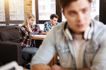 Pleasant friends sitting in the cafe