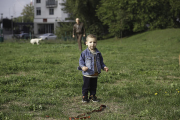 Portrait of little boy walking in park