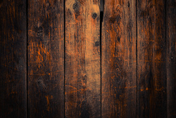 Old rural wooden wall in dark brown and orange colors, detailed plank photo texture. Natural wooden building structure background.