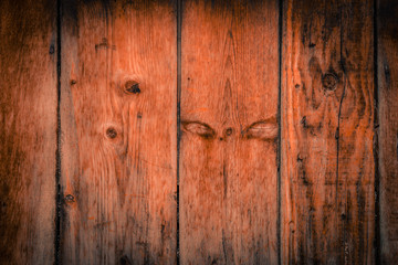 Fototapeta premium Old rural wooden wall in dark brown and orange colors, detailed plank photo texture. Natural wooden building structure background.
