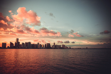 Miami Florida sunset over downtown business and luxury residential buildings, hotels and illuminated bridge over Biscayne Bay. Cityscape of World famous travel destination. Florida. USA