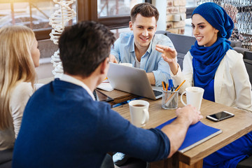 Positive international students studying together