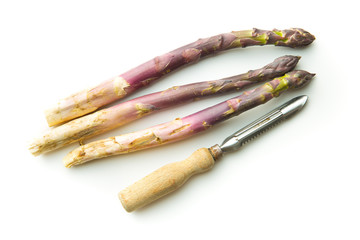 Fototapeta premium Fresh purple asparagus with peeler.