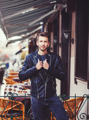 Handsome man on leather jacket in city
