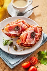 Gourmet fried tostada with prosciutto ham