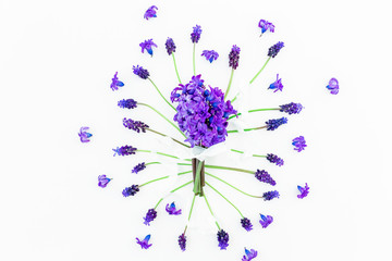 Bouquet of blue hyacinth with tapes and pattern of muscari flowers on white background. Flat lay, top view.