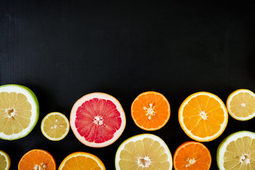 Fruit colorful background. Citrus fruits isolated on dark background. Flat lay, top view.
