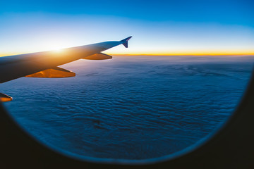 Fototapeta na wymiar Aerial view from airplane window at sunset