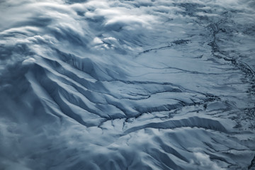 Naklejka na ściany i meble Aerial view from air plane of snow mountains