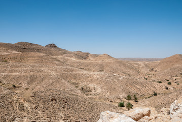 Mountains in the desert with the remains of old stone walls