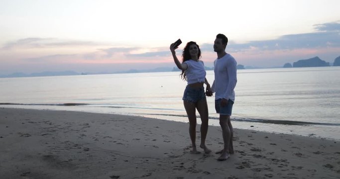 Couple Taking Selfie Photo On Beach At Sunset, Man And Woman Tourists Slow Motion 60